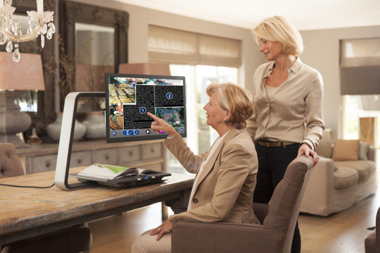 Photo of Optelec Clearview C Plus Speech on Kitchen Island with two women users