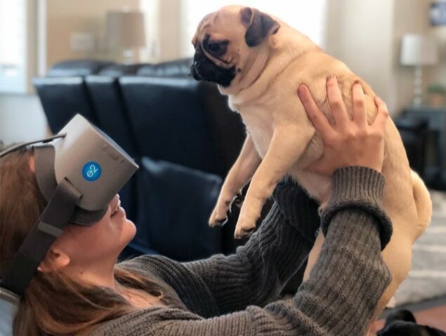 Person wearing NuEyes e2 holding a dog
