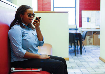 Person sitting and speaking into her smartphone