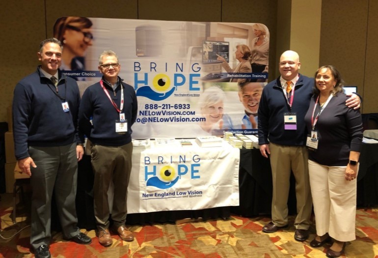 NELVB Team standing in front of our booth at 2019 NEAER Conference