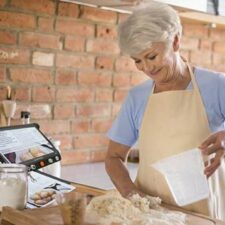 Woman using Looky Book Pro in the kitchen while baking
