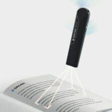 OrCam read smart device being used to read a book
