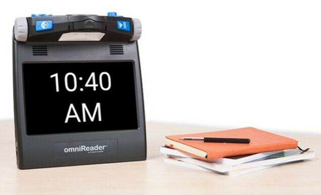 omniReader on table with books and time on monitor