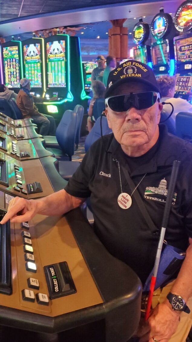 Person at a casino wearing Eyedaptic Eye4SE Low Vision Glasses