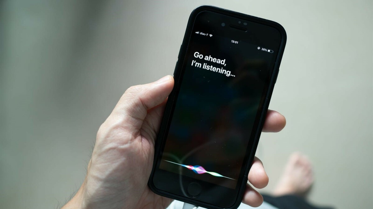 Picture of hand holding a smartphone asking Siri a question