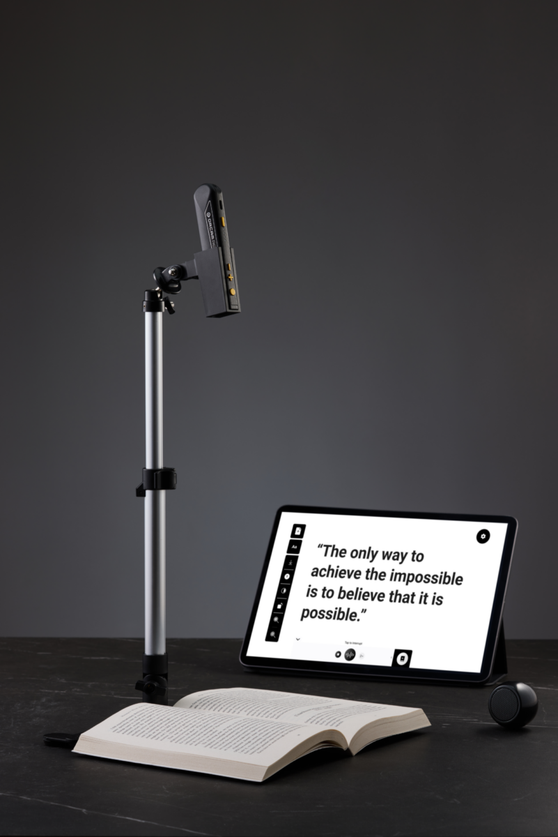 OrCam Read 3 on stand with tablet on table