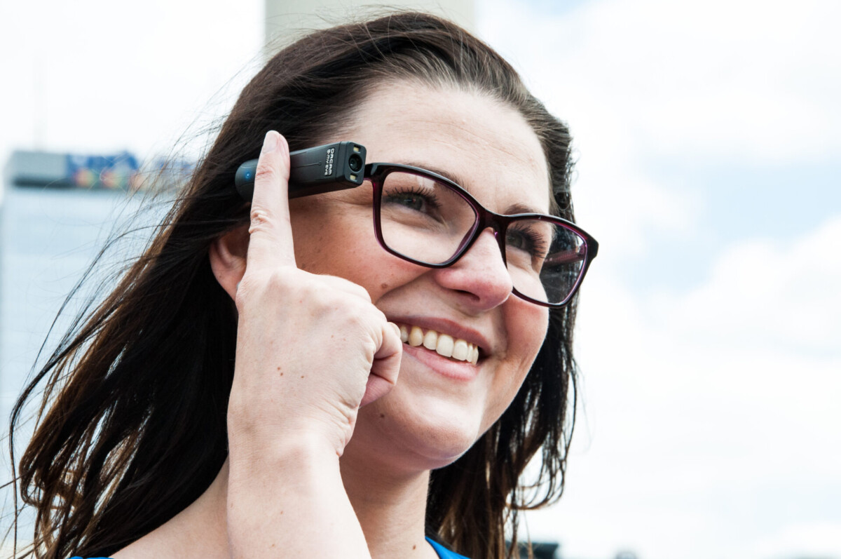 OrCam MyEye Pro person wearing touching the side