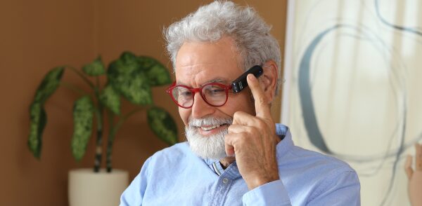 OrCam MyEye Pro person wearing touching the side