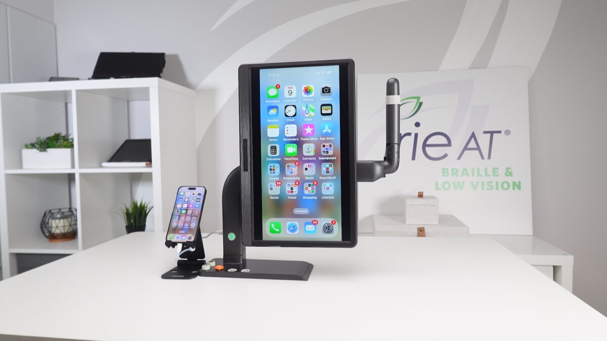 Mirror Pad Plus Desktop Magnifier in vertical position with with smartphone to the left on the desk