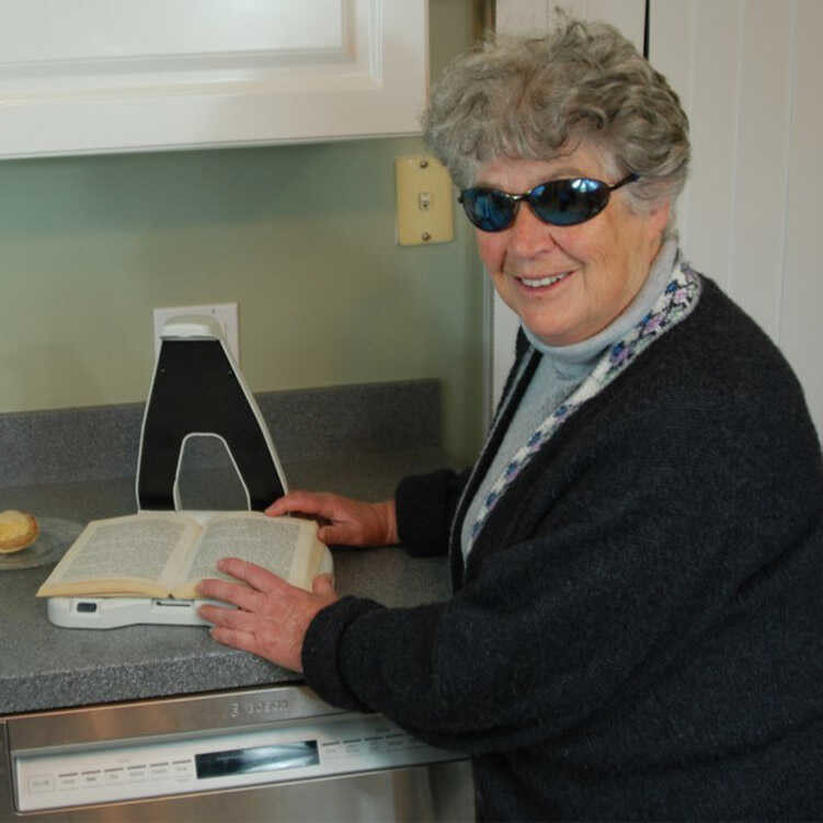Blindness Accessories- Woman using Lyriq Assistive Reader